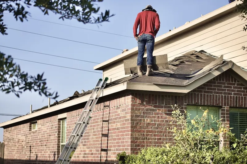 Professional roofer working on a residential roof in Garrison